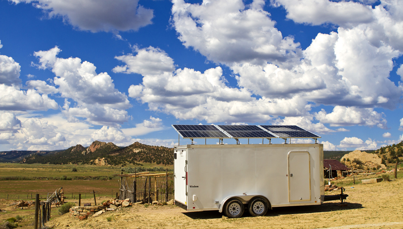 Designed to bring power to those in need, a solar trailer belonging to the Shonto Community Development Corporation has mounted panels on the roof and a battery and control console inside.