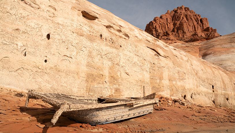 A boat emerges from the drying lakebed.