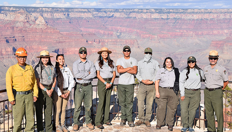 Native employees pose at the rim of the Grand Canyon