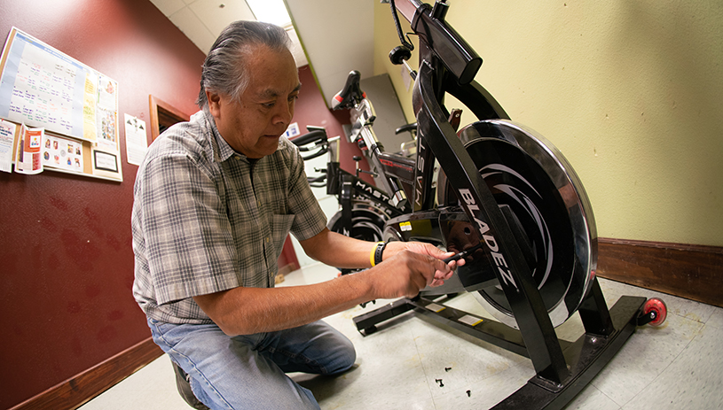 Samuel Shingotewa fixing a spin bike