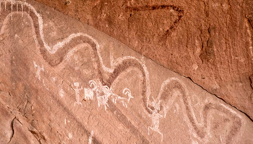 A snake pictograph painted on an alcove wall.