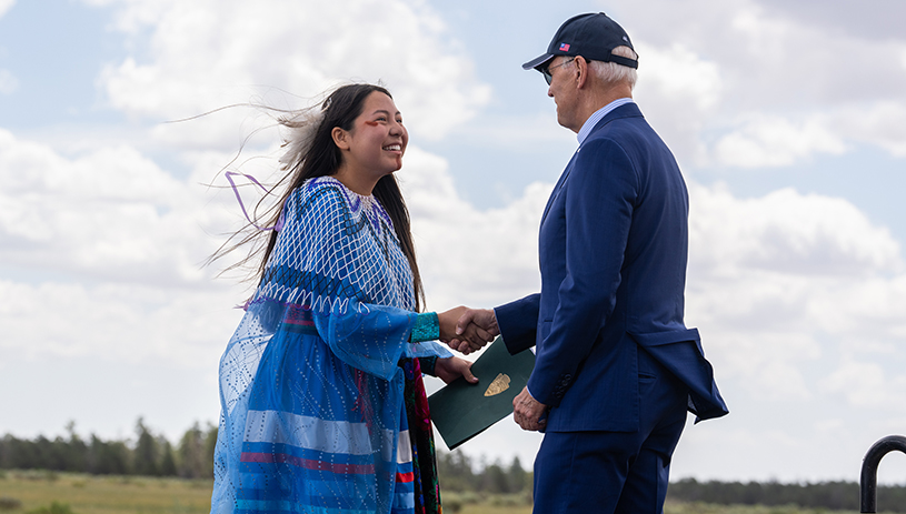 Maya Tilousi-Lyttle (left) delivered remarks and introduced President Joe Biden (right) at the Historic Red Butte Airfield on August 8, 2023 before he signed a proclamation establishing Baaj Nwaavjo I’tah Kukveni – Ancestral Footprints of the Grand Canyon National Monument. OFFICIAL WHITE HOUSE PHOTO BY CAMERON SMITH