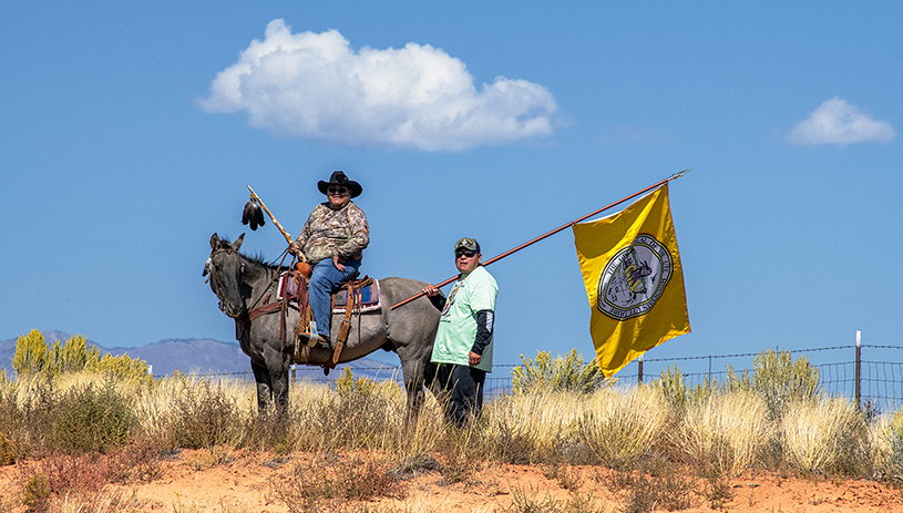 Ute Mountain Ute Tribal Councilman and White Mesa Representative Malcolm Lehi (on horseback) and Councilman Conrad Jacket (holding flag) accompanied walkers. TIM PETERSON