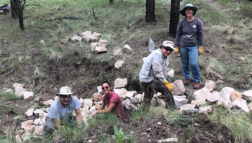 Volunteers build rock structures at Lockwood Draw