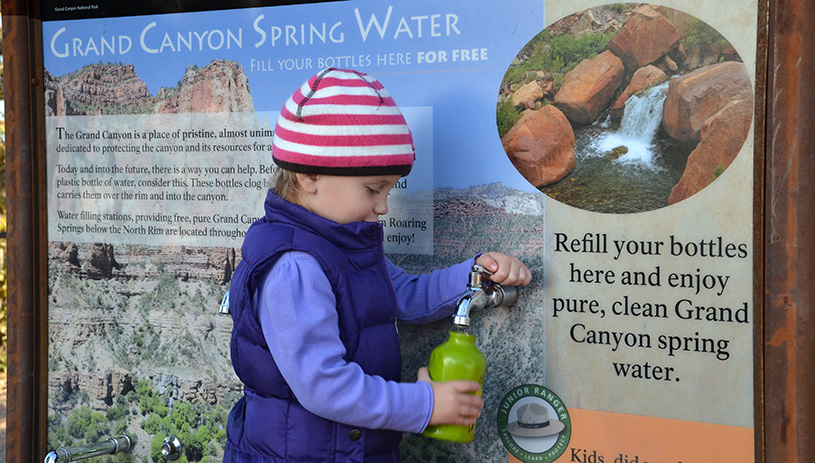 A child fills their water bottle at the Grand Canyon