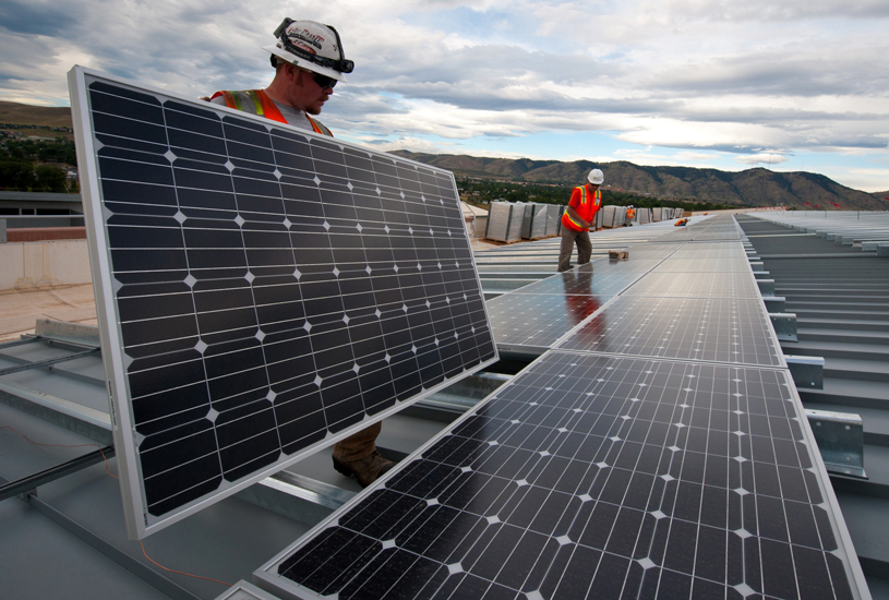 Workers install solar panels on a roof in Golden, Colorado. Photo by Dennis Schroeder courtesy of Department of Energy