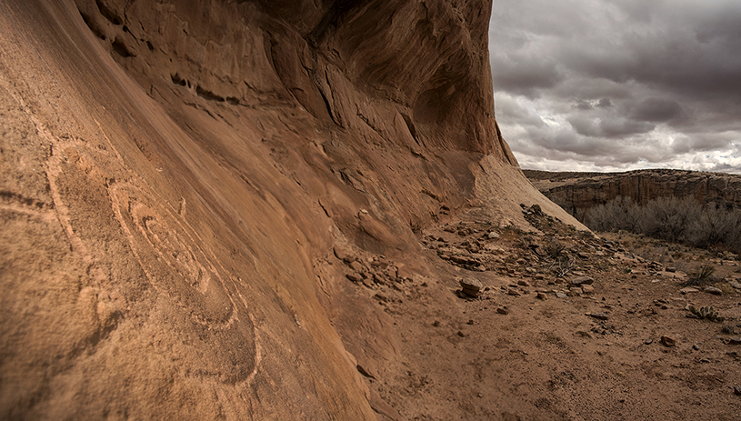 A sun-like petroglyph shines from an alcove on lands removed from Bears Ears National Monument. TIM PETERSON