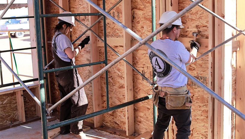 Volunteers help build a house