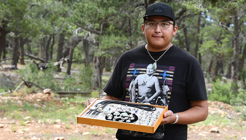 Colton holds some of his silversmith work.