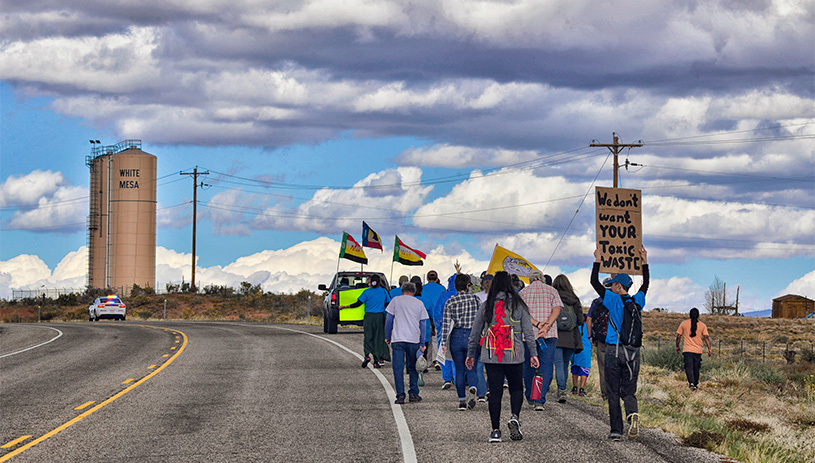 Members of the White Mesa community lead a spiritual walk to protest the White Mesa Mill.