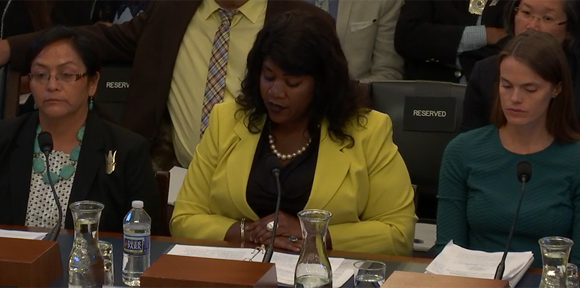 Coral Evans (center) testifies in Congress