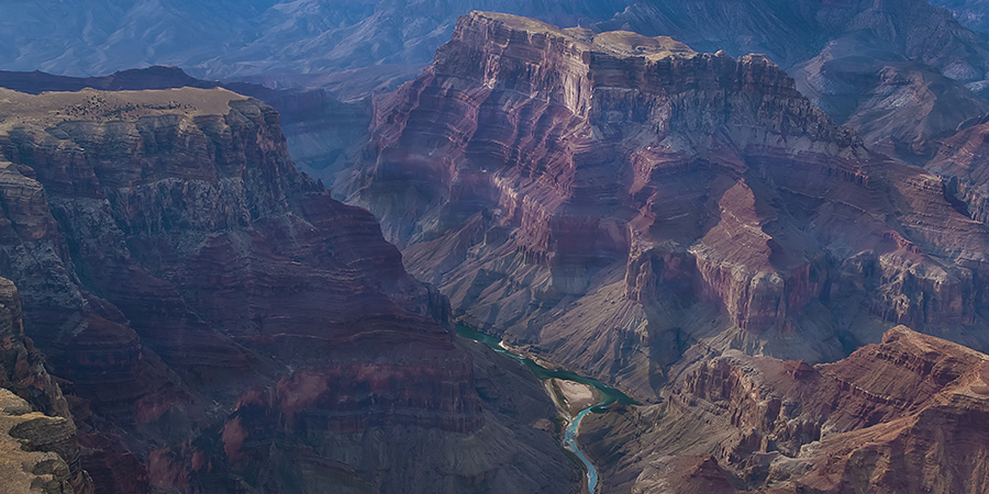 Aerial view of the confluence in the Grand Canyon, turquoise Little Colorado River meets Green Colorado river, tiny ribbons at the bottom of the canyon