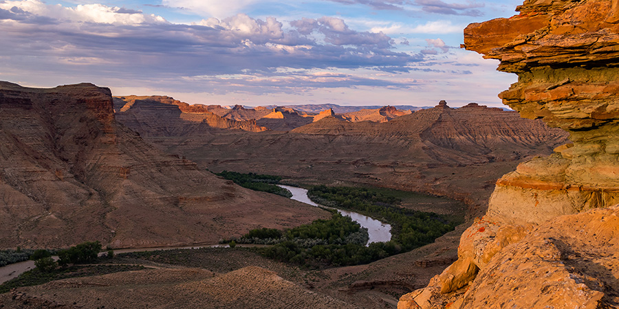 Rock cliffs looking down on ribbon of White River flowing through greenery near the site of the proposed Enefit oil shale project.
