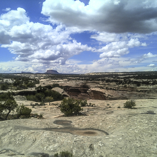 A slickrock view with blue sky and big clouds