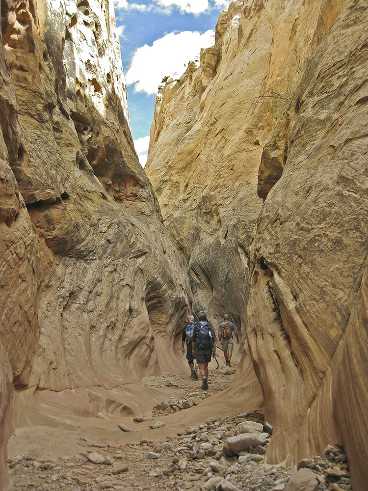 Hikers in a Navajo Sandstone slot canyon