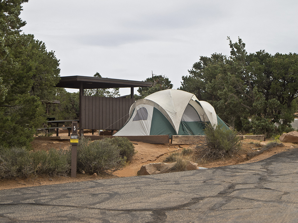 A tent next to a brown shade structure