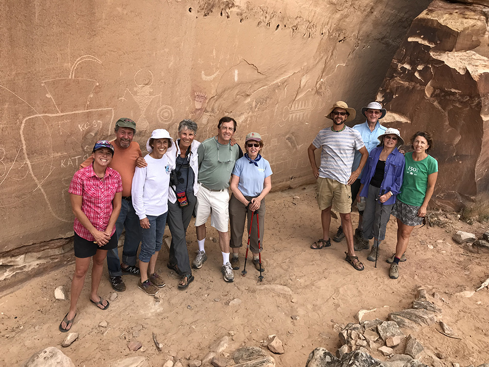 A group of Trust donors pose near petroglyphs.