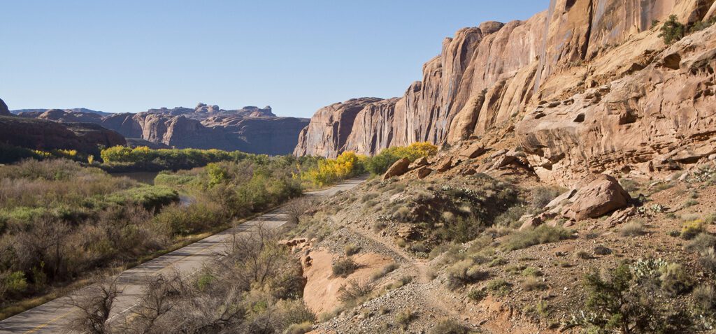 A trail skirts below sandstone cliffs