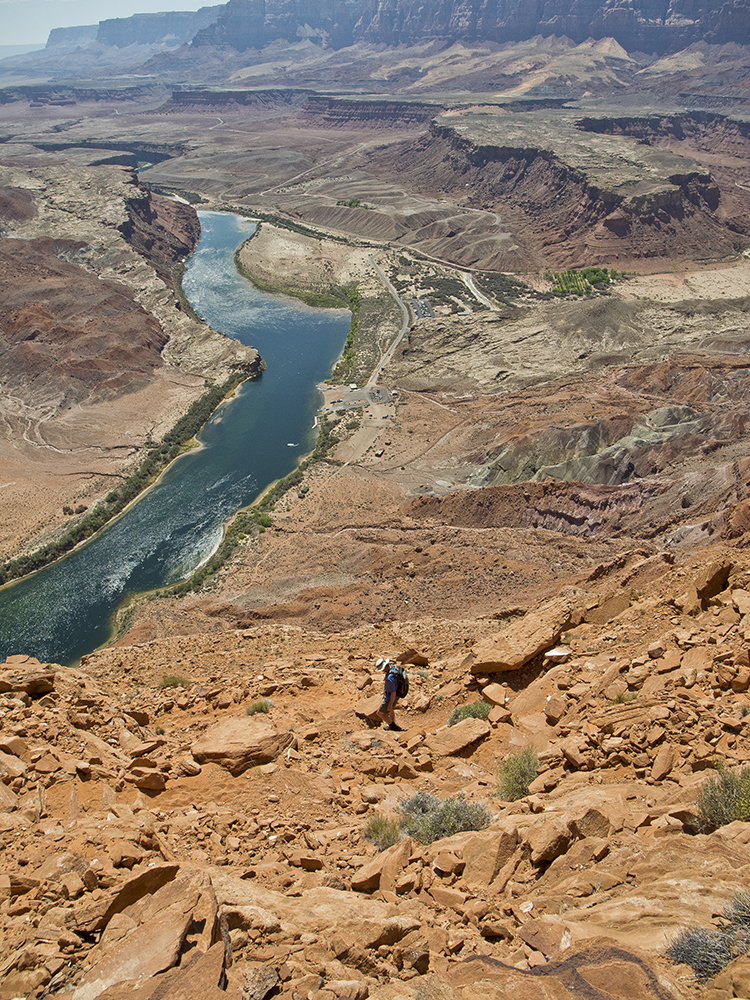 A hiker on the Spencer Trail with the Colorado River below