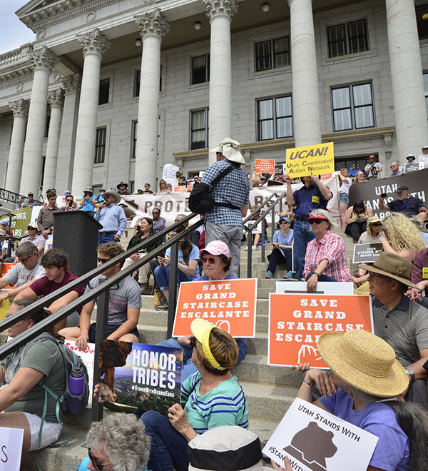 Protesters take action on the steps of the Utah state capitol holding signs advocating for the protection of Bears Ears National Monument