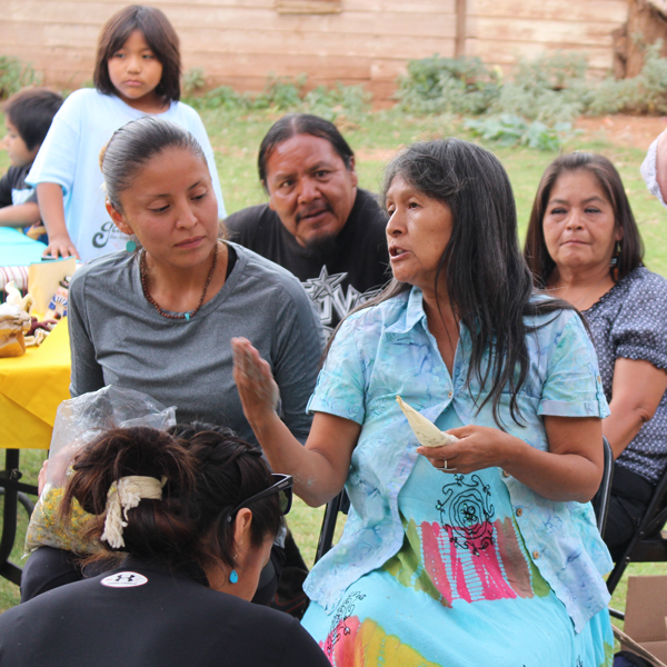 Tribal members converse at an intertribal gathering