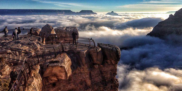 A rare total inversion was seen today by visitors to Grand Canyon National Park. This view is from Mather Point on the South Rim, visitors behind a railing on a rock lookout, Grand Canyon filled with clouds